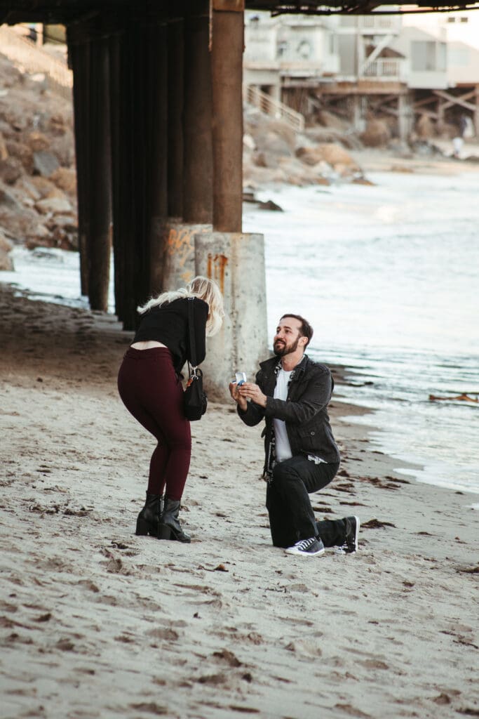 Couple getting engaged on the beach in Malibu, California