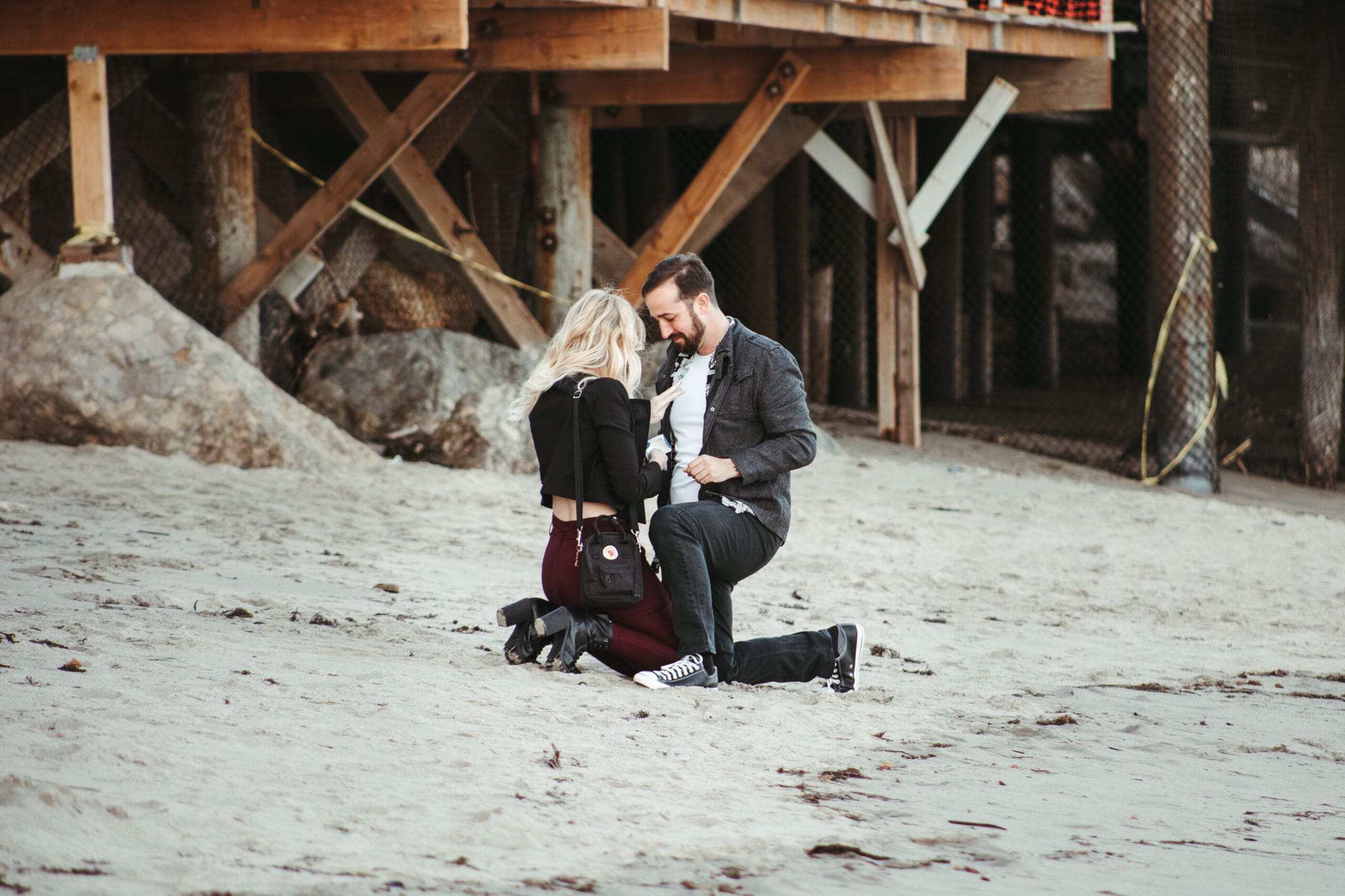 Couple getting engaged on the beach in Malibu, CA