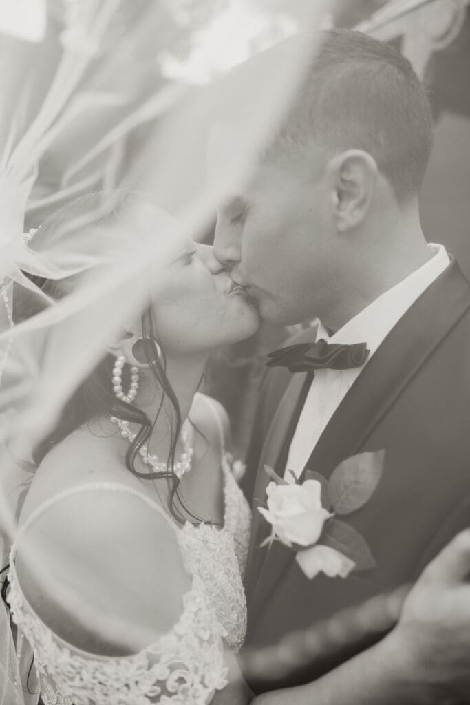 Newlyweds kissing at wedding in Southern California