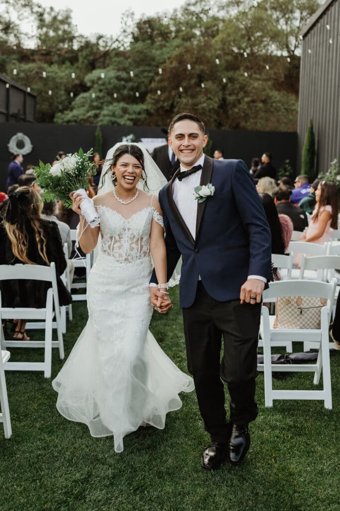 Newlyweds walking down the aisle at wedding in Southern California